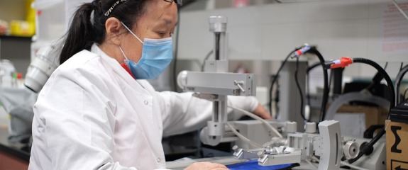 Researcher testing results with machine.