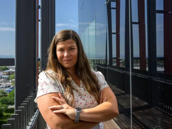 portrait of tally largent-milnes on a building balcony overlooking Tucson