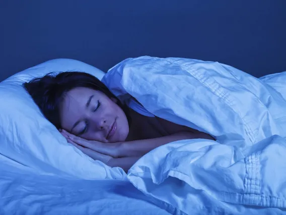 person lying on side in bed sleeping peacefully