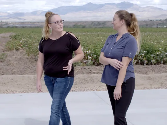 two woman walk and talk in rural Safford, Arizona