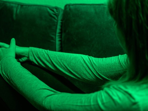 person sitting on a couch doing green light therapy