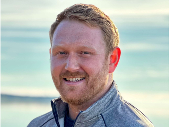 portrait of Christopher Cartmell wearing University of Arizona quarter-zip shirt