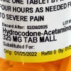 Close-up of prescription bottle with instructions for taking hydrocodone-acetaminophen for pain