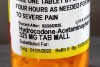 Close-up of prescription bottle with instructions for taking hydrocodone-acetaminophen for pain